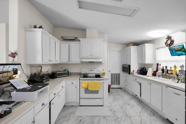 a kitchen with stainless steel appliances a stove a sink a stove a microwave and cabinets