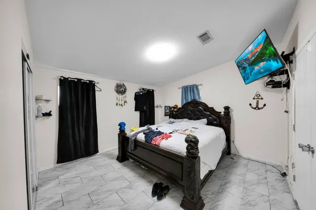 a bed room with a bed and a flat screen tv