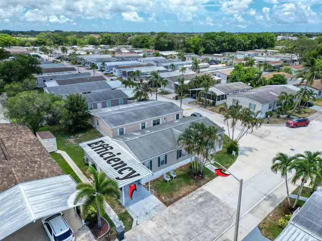 an aerial view of multiple houses with a yard