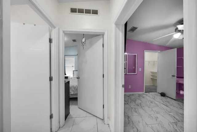 a view of a hallway with bathroom and bathroom