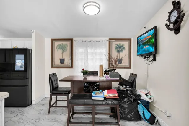 a living room with furniture a flat screen tv and a window
