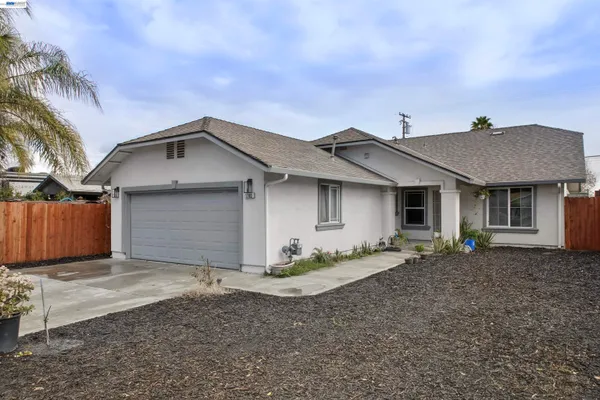 a front view of a house with a garden and yard