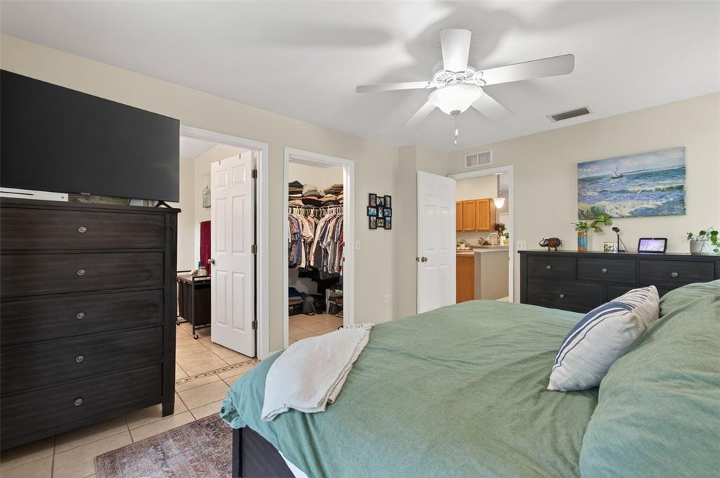 4729 Northeast 16th Terrace Gainesville, FL 32609 - Photo 14 of 41 a bed room with a bed and a flat tv screen