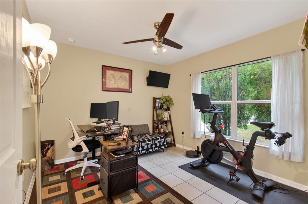 4729 Northeast 16th Terrace Gainesville, FL 32609 - Photo 26 of 41 a view of a workspace with furniture and a ceiling fan