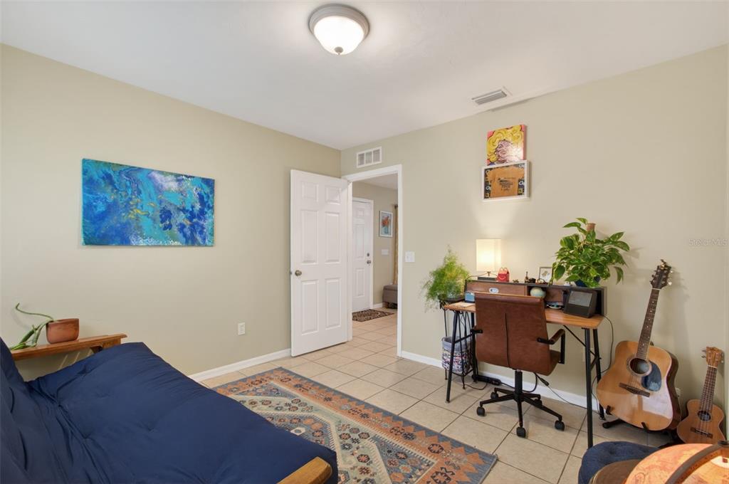 4729 Northeast 16th Terrace Gainesville, FL 32609 - Photo 27 of 41 a workspace with furniture and rug