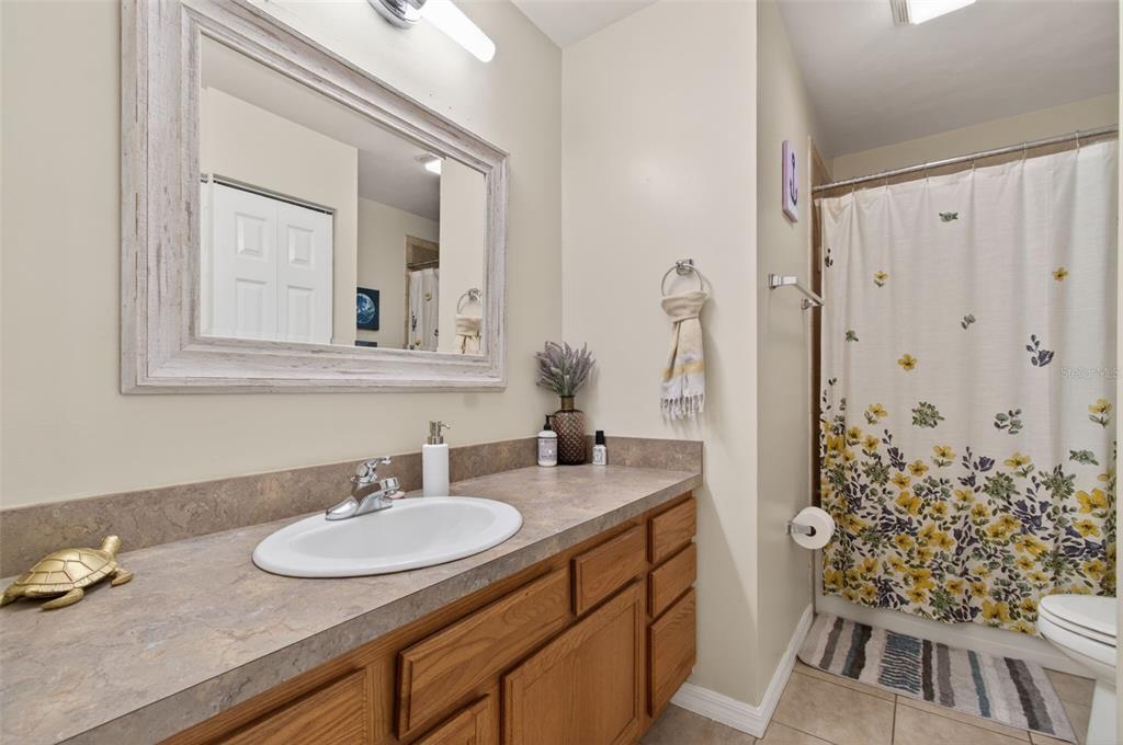 4729 Northeast 16th Terrace Gainesville, FL 32609 - Photo 28 of 41 a bathroom with a double vanity sink and a mirror