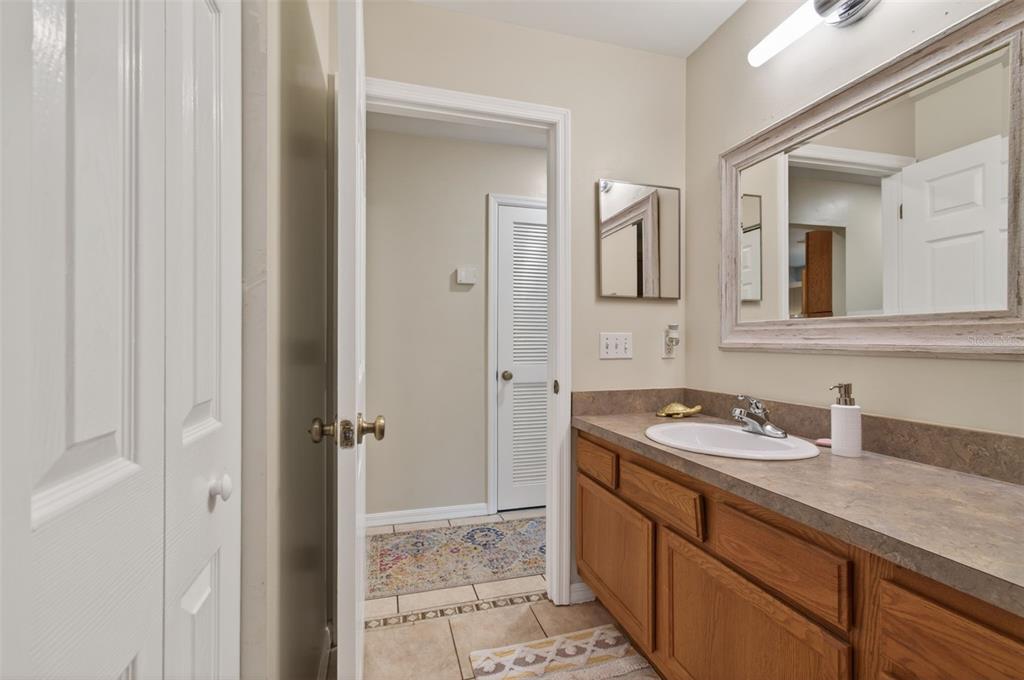 4729 Northeast 16th Terrace Gainesville, FL 32609 - Photo 29 of 41 a bathroom with a sink and a mirror