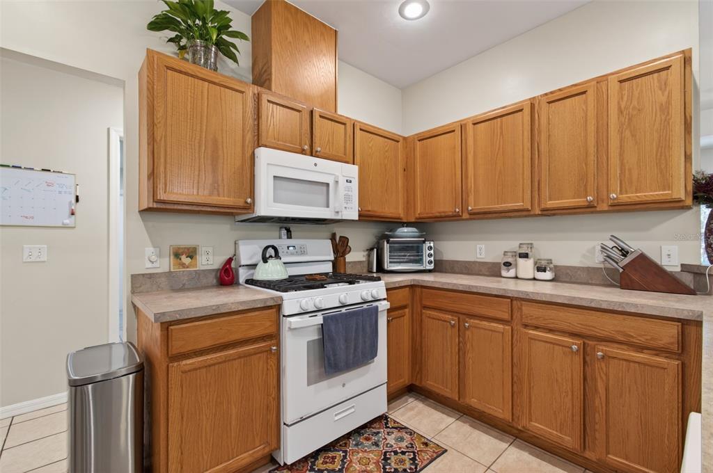 4729 Northeast 16th Terrace Gainesville, FL 32609 - Photo 8 of 41 a kitchen with stainless steel appliances granite countertop a sink stove and cabinets