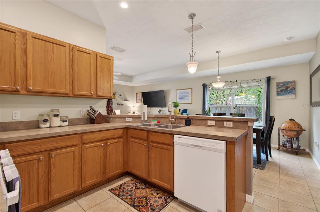 4729 Northeast 16th Terrace Gainesville, FL 32609 - Photo 9 of 41 a kitchen with lots of counter top space sink dining table and chairs