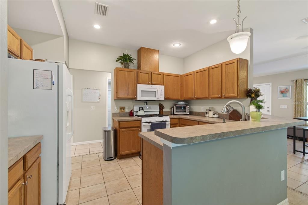 4729 Northeast 16th Terrace Gainesville, FL 32609 - Photo 10 of 41 a kitchen with stainless steel appliances granite countertop a sink stove and refrigerator