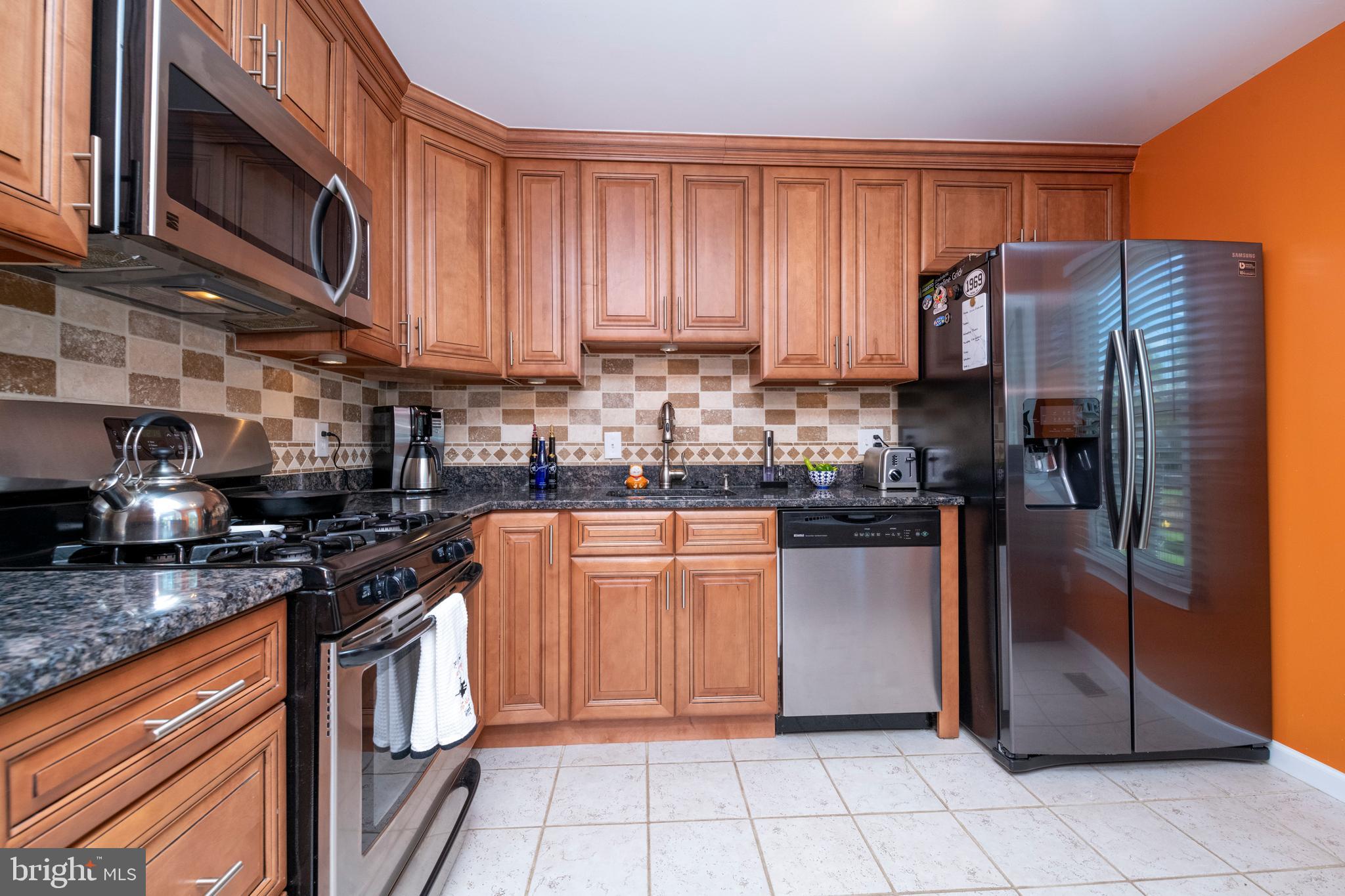 5014 Tartan Hill Road Perry Hall, MD 21128 - Photo 13 of 43 a kitchen with stainless steel appliances granite countertop a refrigerator stove top oven and sink