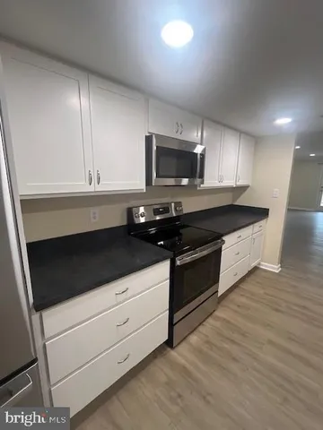 a kitchen with a sink stove and microwave