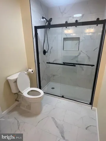 a bathroom with a sink toilet and mirror