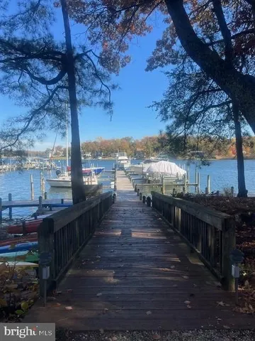 a view of a balcony with wooden floor and outdoor seating