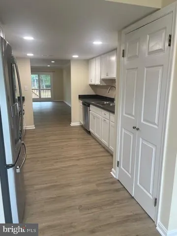 a view of a refrigerator in kitchen and wooden floor