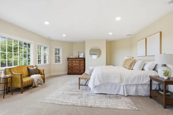 a spacious bedroom with a large bed and a large window