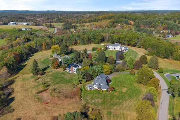 an aerial view of a house with swimming pool and porch