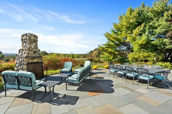 a view of a patio with couches and table and chairs and potted plants