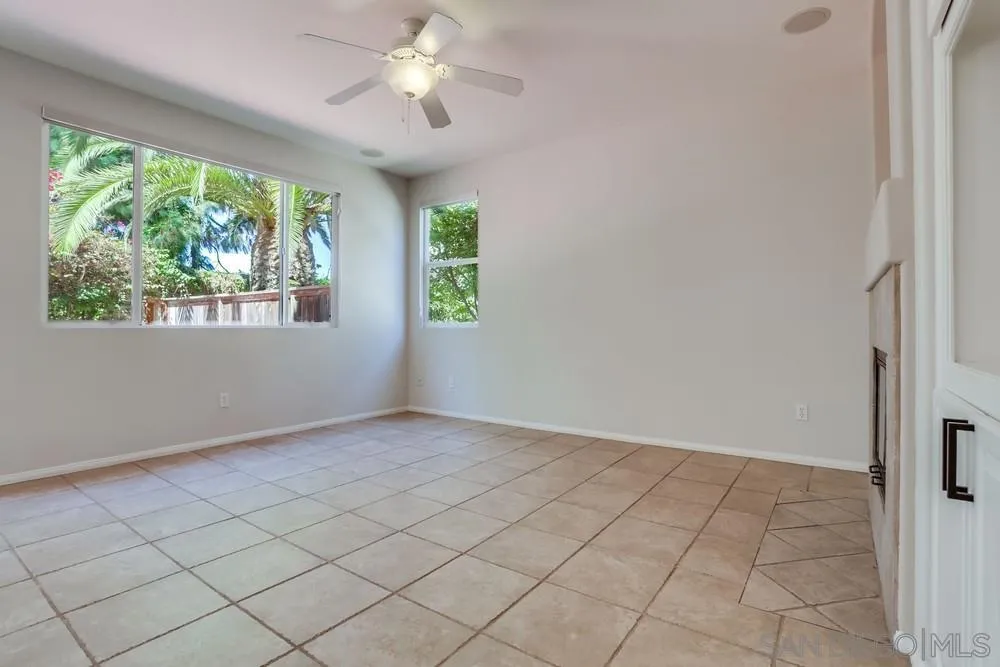 5423 Foxtail Loop Carlsbad, CA 92010 - Photo 15 of 53 an empty room with windows and chandelier fan