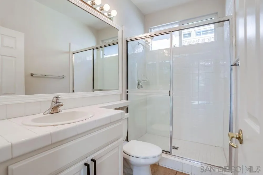 5423 Foxtail Loop Carlsbad, CA 92010 - Photo 22 of 53 a bathroom with a sink toilet and shower