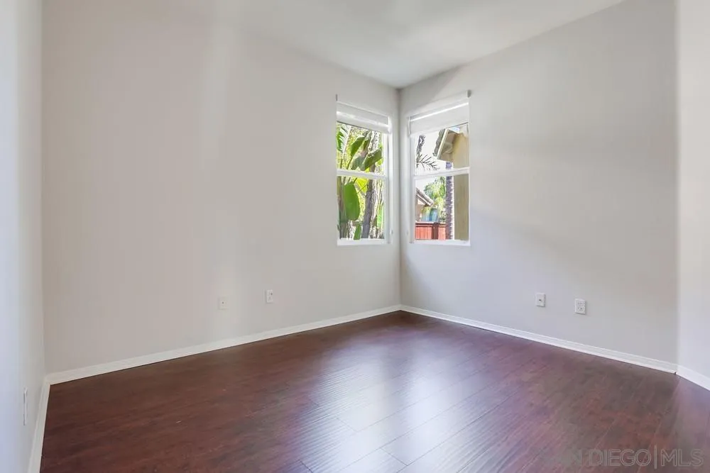 5423 Foxtail Loop Carlsbad, CA 92010 - Photo 23 of 53 an empty room with window and wooden floor