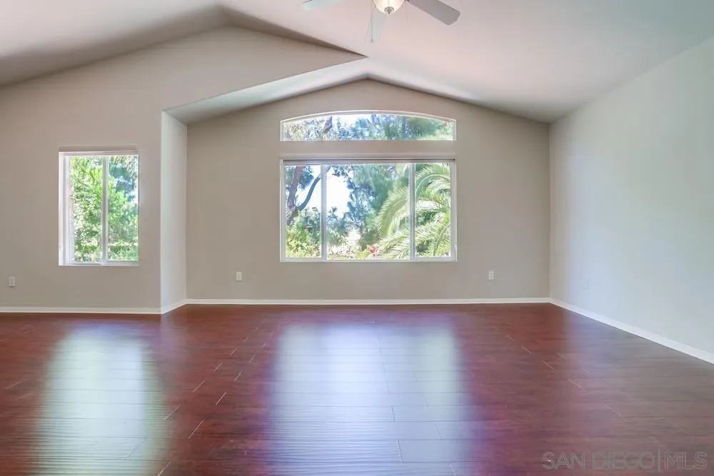 5423 Foxtail Loop Carlsbad, CA 92010 - Photo 28 of 53 an empty room with wooden floor and windows
