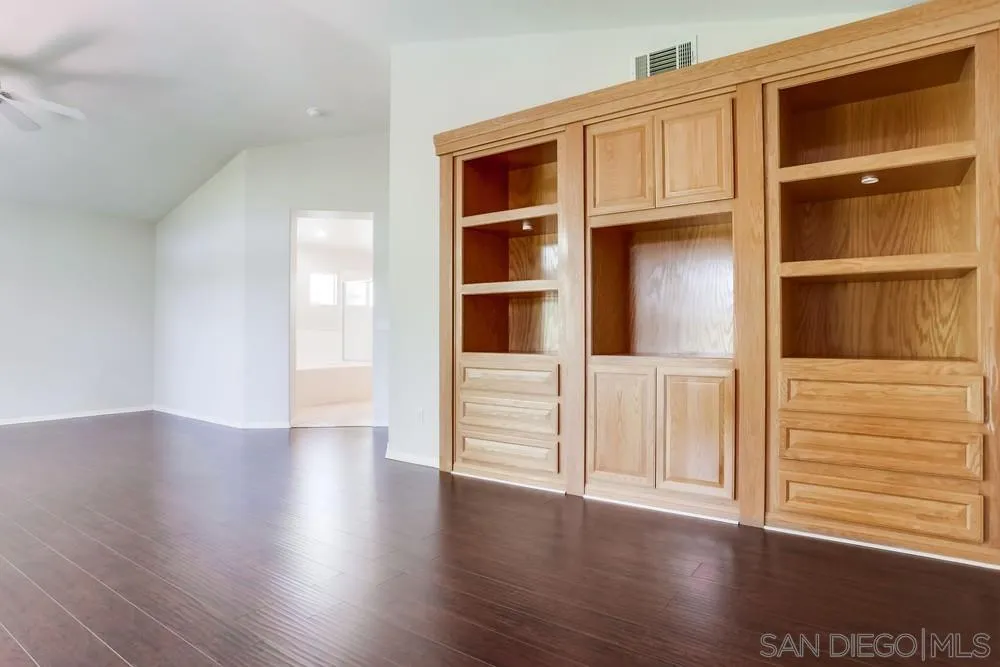 5423 Foxtail Loop Carlsbad, CA 92010 - Photo 31 of 53 a view of an empty room with wooden floor and entryway