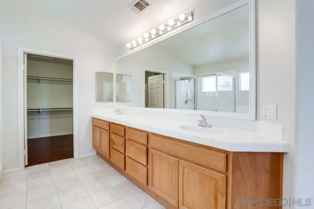 a large bathroom with a tub and shower