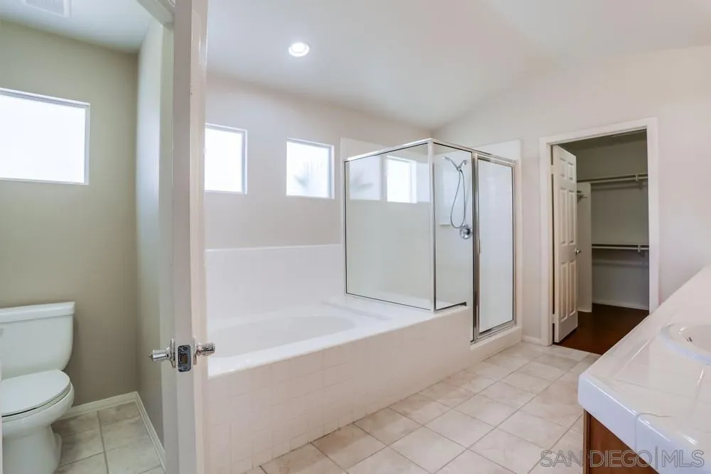 5423 Foxtail Loop Carlsbad, CA 92010 - Photo 36 of 53 a spacious bathroom with a bathtub and a toilet