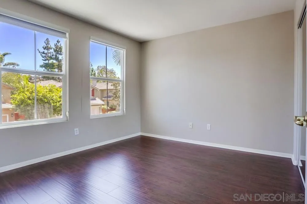 5423 Foxtail Loop Carlsbad, CA 92010 - Photo 38 of 53 a view of an empty room with wooden floor and a window