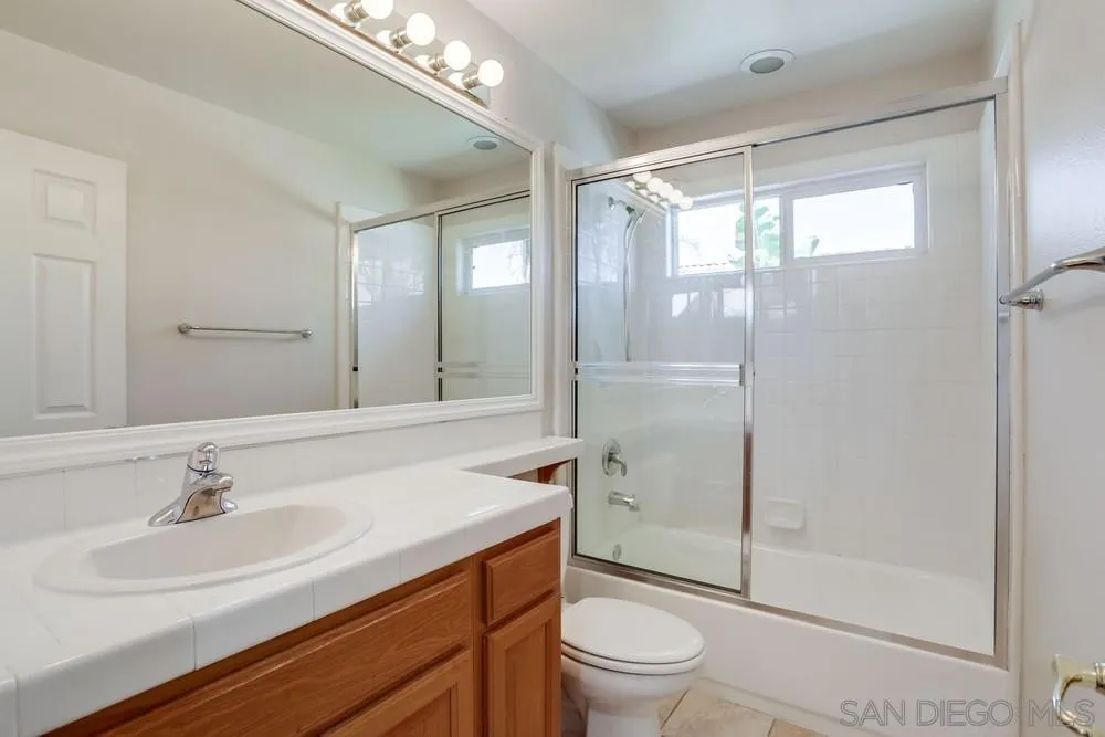 5423 Foxtail Loop Carlsbad, CA 92010 - Photo 42 of 53 a bathroom with a sink toilet a mirror and shower