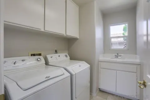 a patio with table and chairs and potted plants