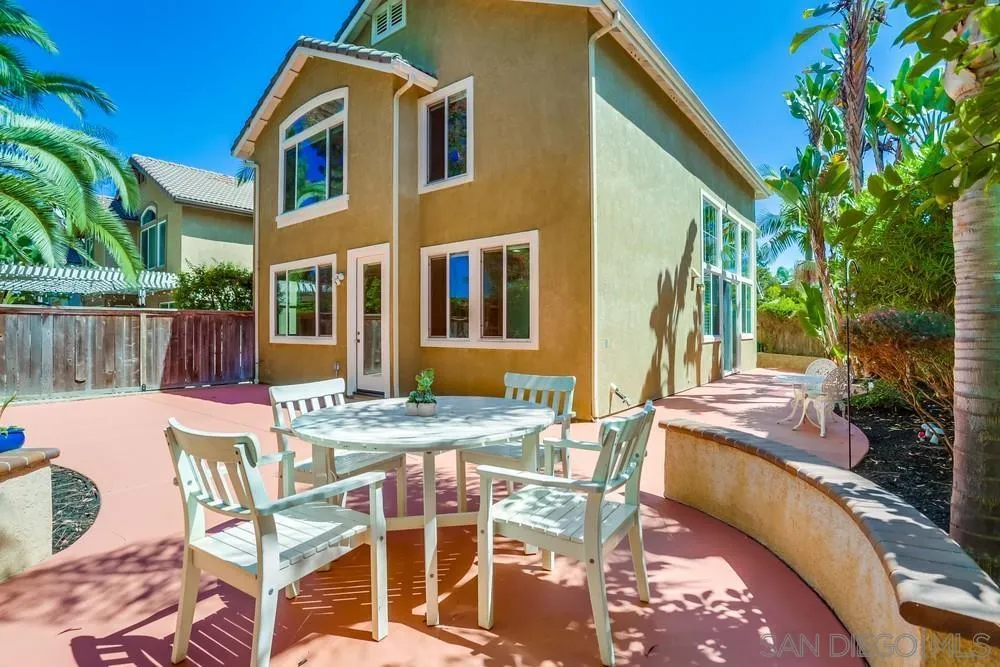 5423 Foxtail Loop Carlsbad, CA 92010 - Photo 46 of 53 a patio with table and chairs and potted plants