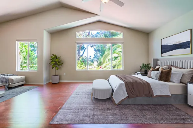 a spacious bedroom with a large bed and a large window