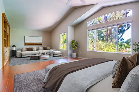 a bedroom with large bed and a large window