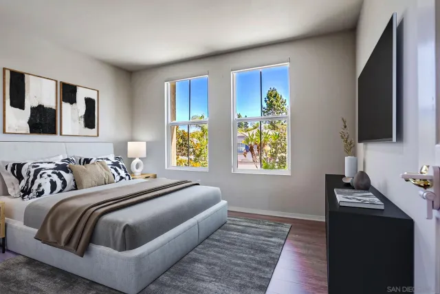 a bedroom with a bed and a flat screen tv