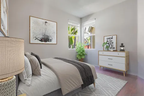 a bedroom with a bed and painting on the wall