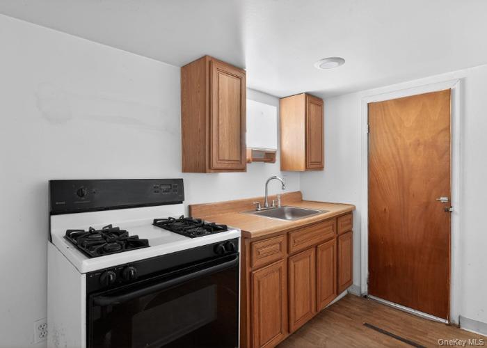 64 Watchogue Road Staten Island, NY 10314 - Photo 12 of 23 a kitchen with a stove and a sink