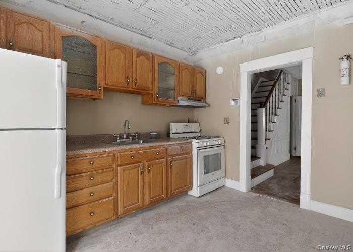 64 Watchogue Road Staten Island, NY 10314 - Photo 13 of 23 a kitchen with granite countertop cabinets and refrigerator