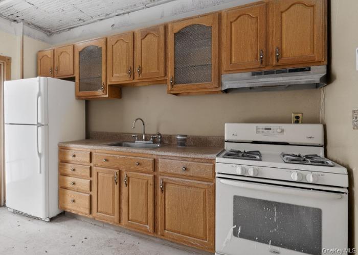 64 Watchogue Road Staten Island, NY 10314 - Photo 14 of 23 a kitchen with stainless steel appliances granite countertop a stove a refrigerator and a white cabinets
