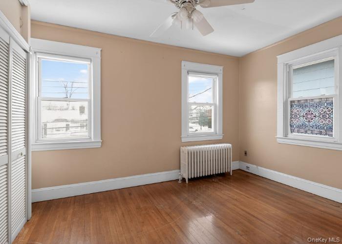 64 Watchogue Road Staten Island, NY 10314 - Photo 15 of 23 a view of an empty room with a window and wooden floor