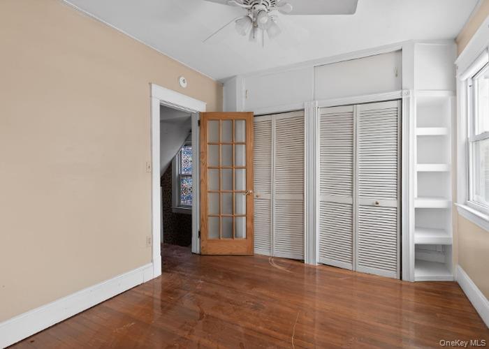 64 Watchogue Road Staten Island, NY 10314 - Photo 16 of 23 an empty room with closet and a chandelier fan
