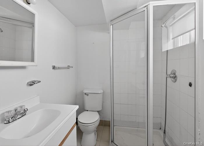 64 Watchogue Road Staten Island, NY 10314 - Photo 21 of 23 a bathroom with a sink and a toilet