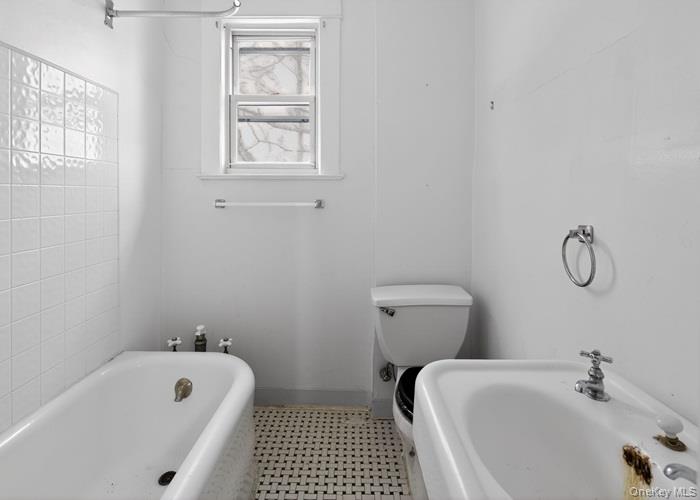 64 Watchogue Road Staten Island, NY 10314 - Photo 23 of 23 a bathroom with a sink a toilet and bathtub