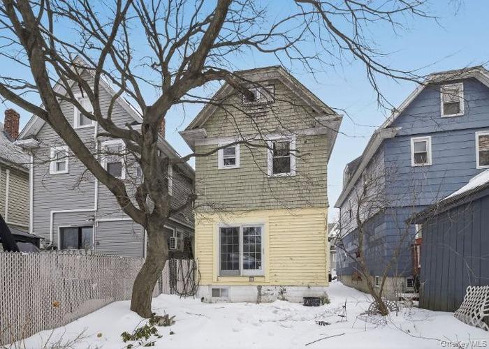 64 Watchogue Road Staten Island, NY 10314 - Photo 3 of 23 a front view of a house with a yard