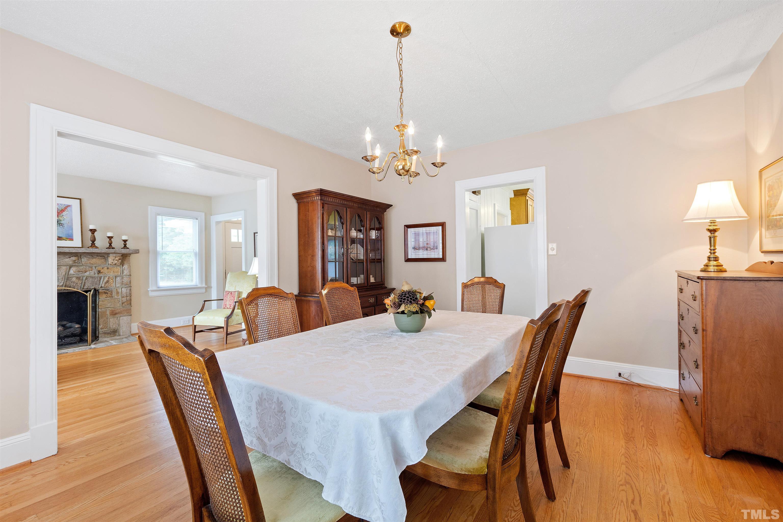 110 Shepherd Street Raleigh, NC 27607 - Photo 20 of 41 a view of a dining room with furniture wooden floor and chandelier