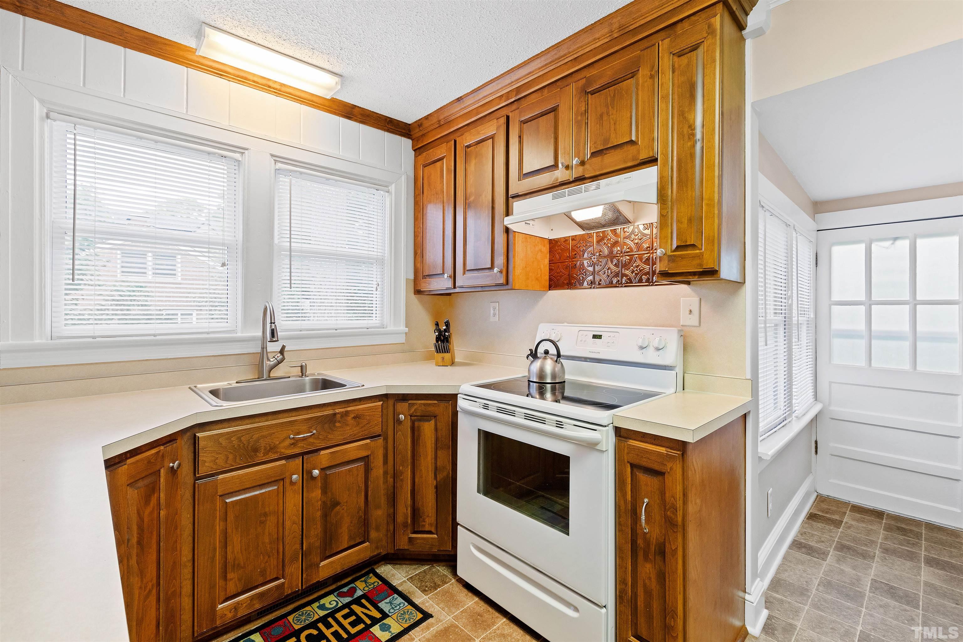 110 Shepherd Street Raleigh, NC 27607 - Photo 22 of 41 a kitchen with stainless steel appliances a stove a sink and a microwave