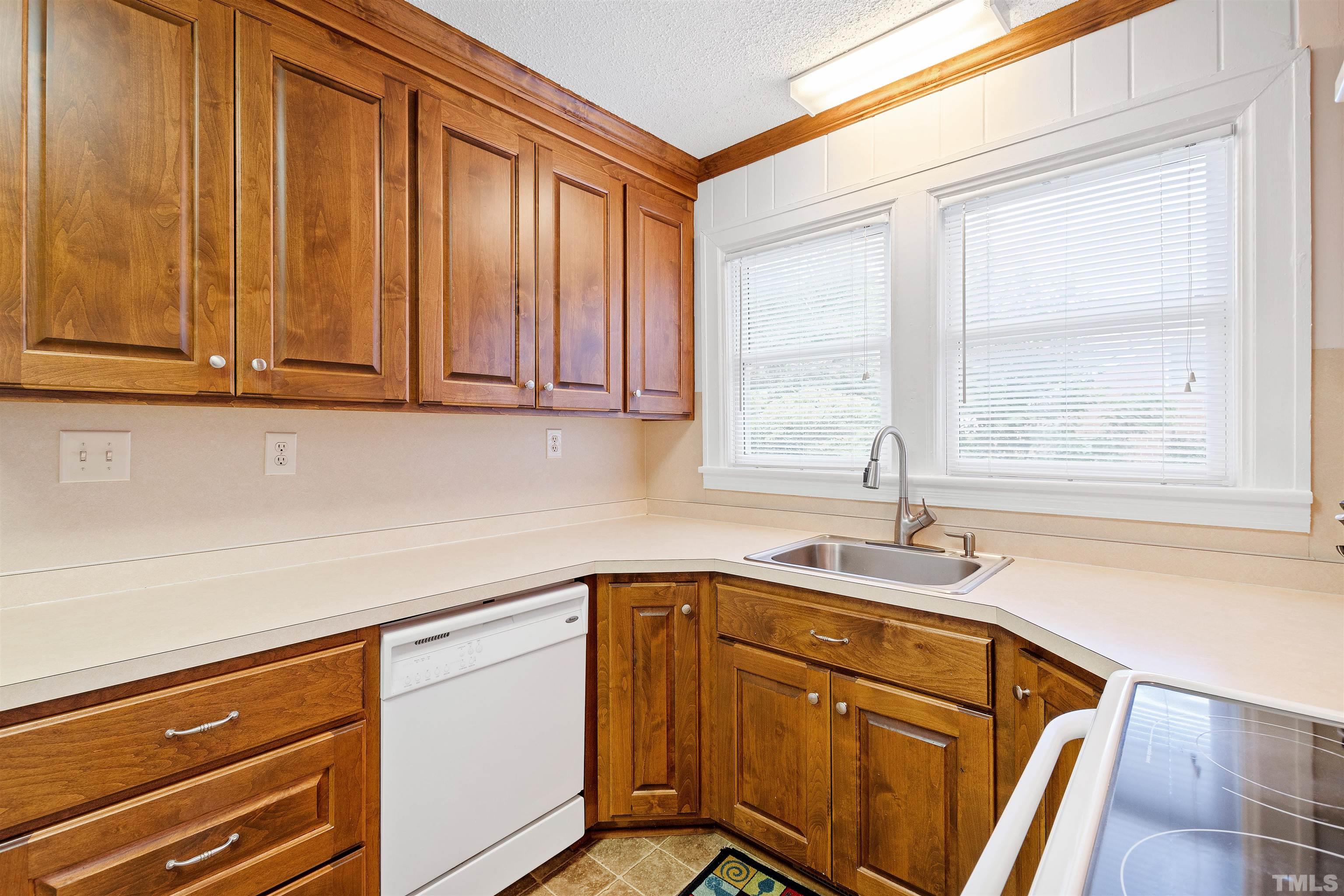 110 Shepherd Street Raleigh, NC 27607 - Photo 23 of 41 a kitchen with a sink cabinets and window