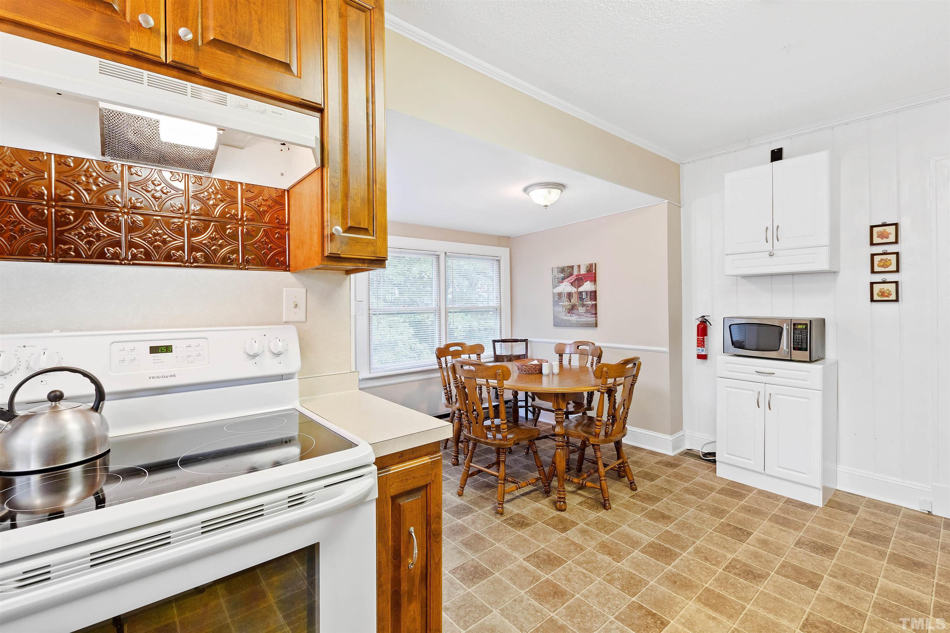 110 Shepherd Street Raleigh, NC 27607 - Photo 24 of 41 a kitchen with a stove and white cabinets