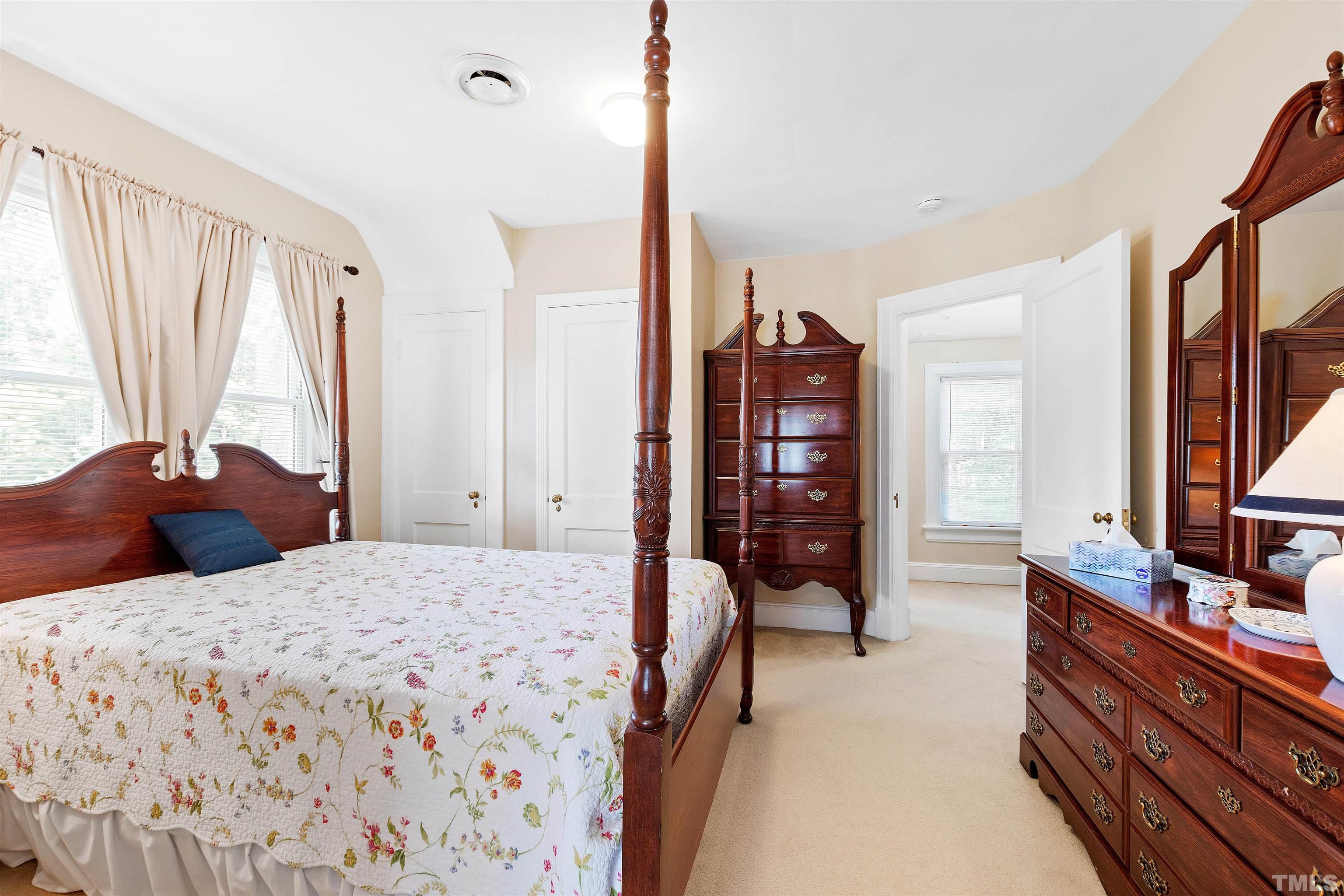 110 Shepherd Street Raleigh, NC 27607 - Photo 29 of 41 a bedroom with a large bed and a flat tv screen on dresser